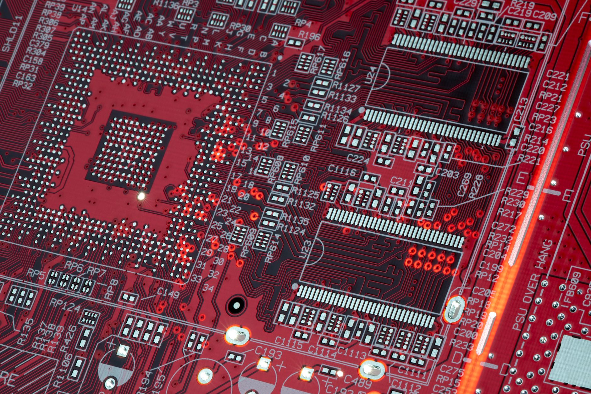 Highlighting the efficiency of modern ASIC miners Detailed shot of a red motherboard showcasing electronic components and circuits.