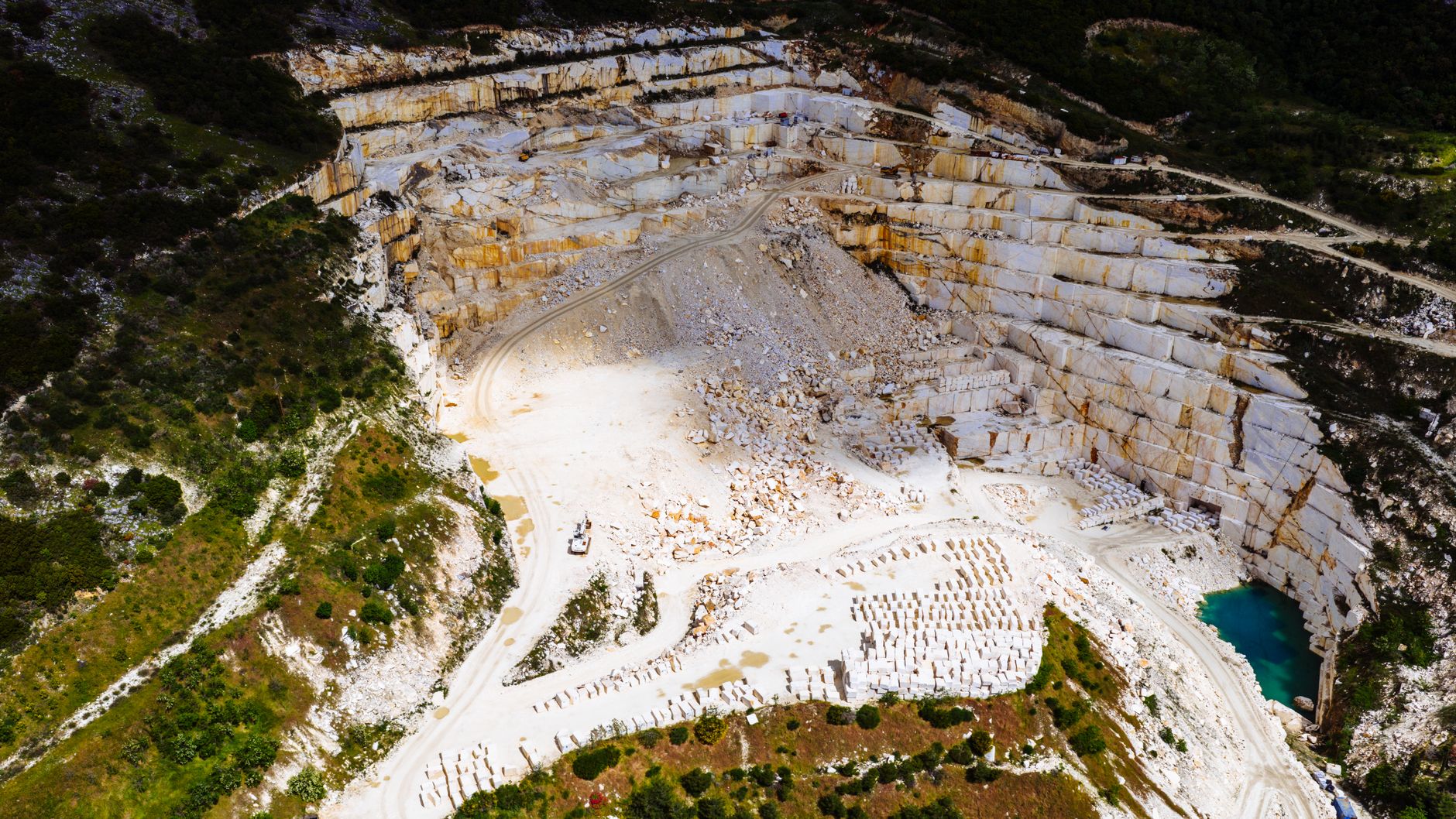 A comprehensive view of a Monero mining operation A breathtaking aerial view of a marble quarry surrounded by lush greenery in Thessaloniki, Greece.