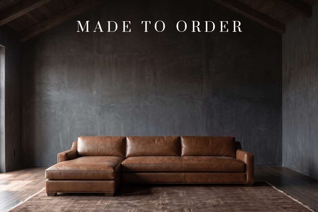 Made to order — a leather sectional in a dark, architectural room