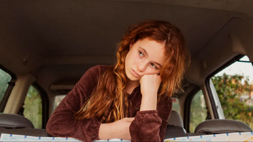 A thoughtful girl resting her head on her hand